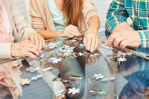 3 mensen zijn een puzzel aan het maken